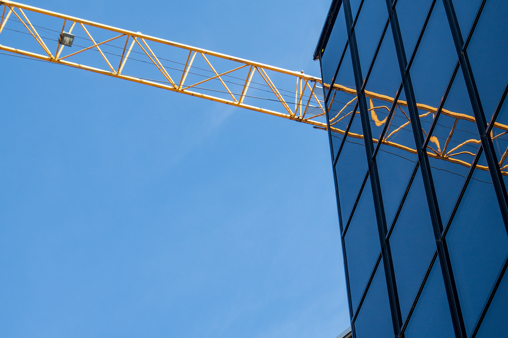 A crane is in front of the building.