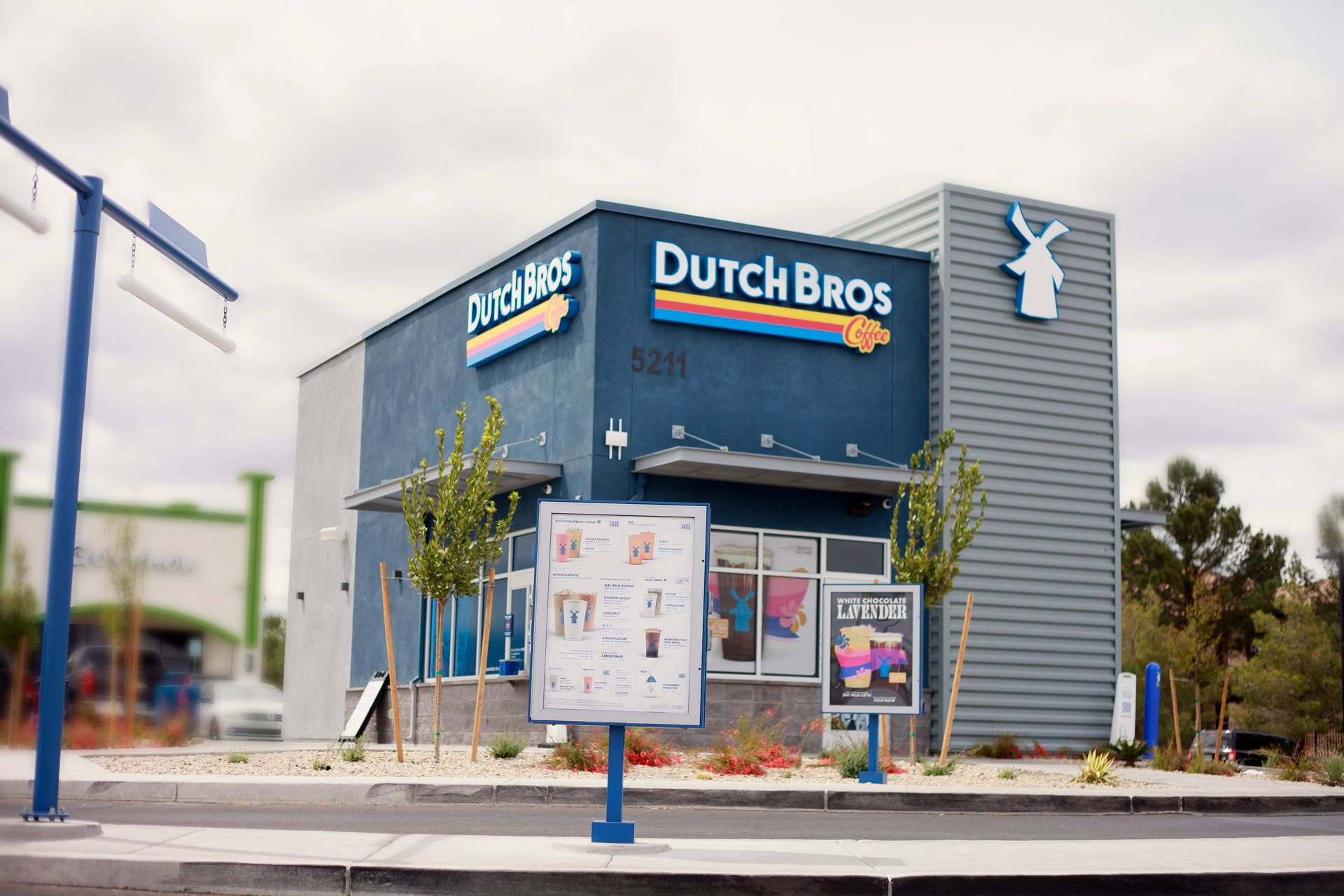 A dutch bros coffee shop with a sign on the side.